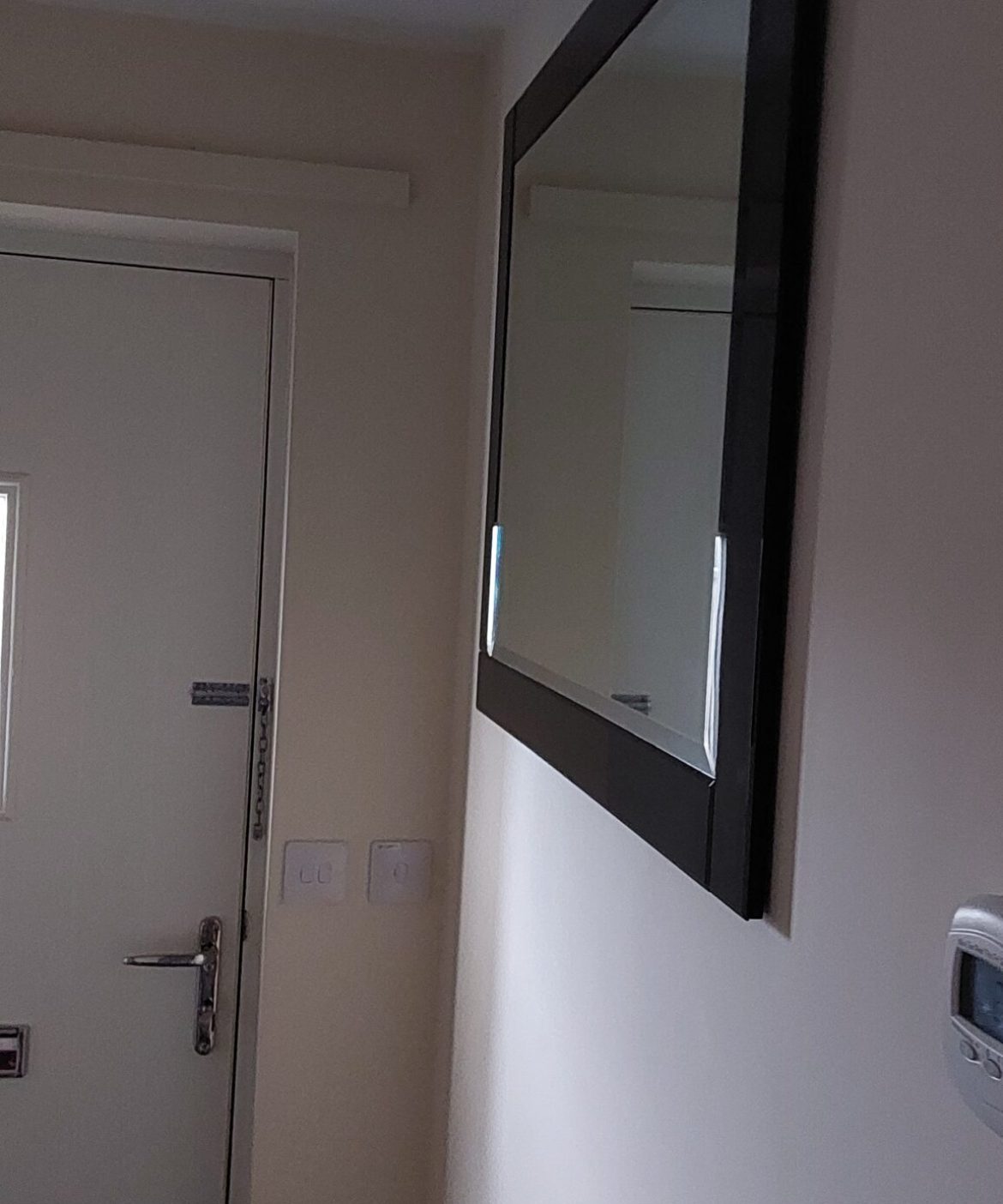 Heavy mirror fixed in hallway