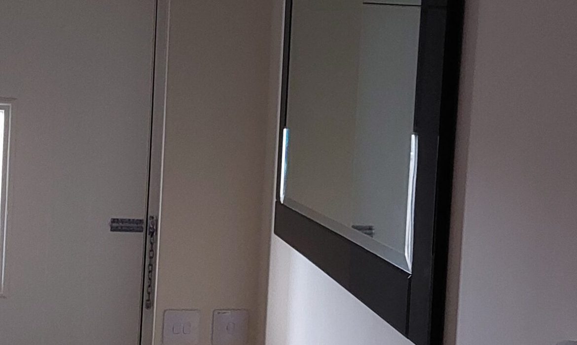 Heavy mirror fixed in hallway